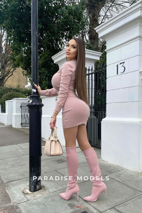Anastasiia in a full pink outfit, showcasing her great shape. 